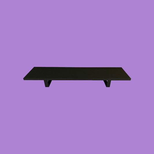 Matte black monitor riser with matte black feet.