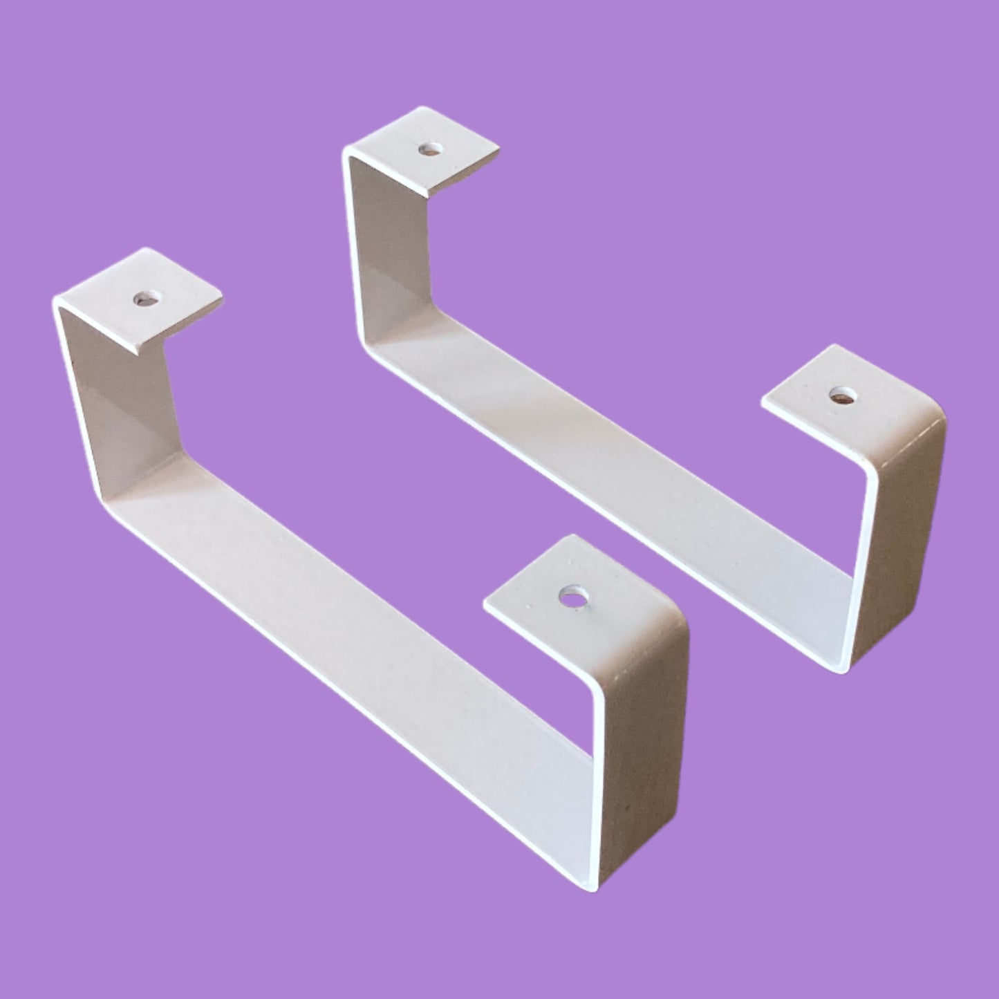 Matte white monitor riser feet.