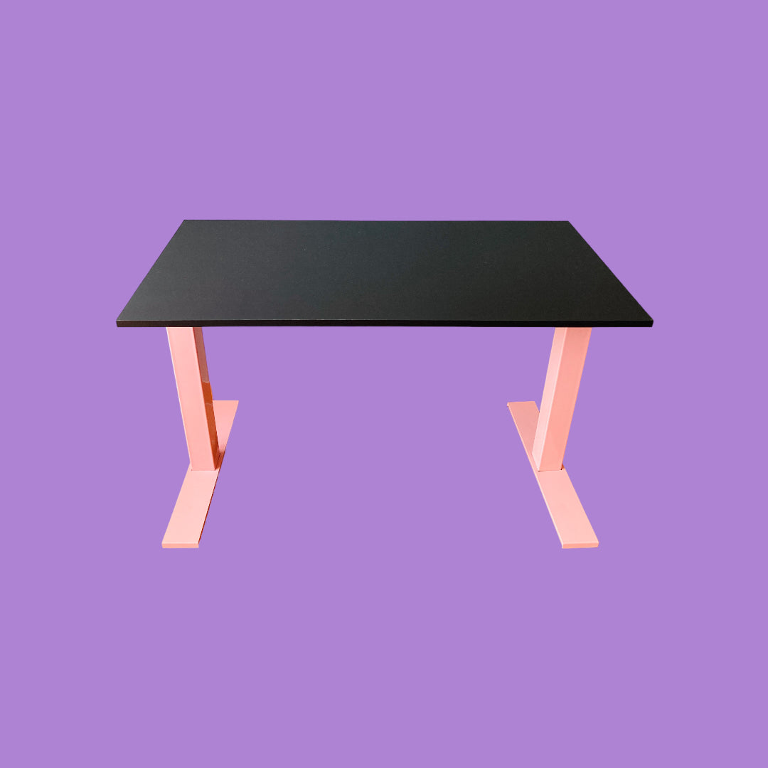 Matte black desk with a pink desk frame.