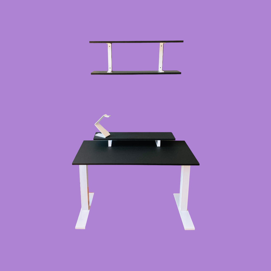 Matte black desk with a matte white desk frame, a matte black monitor riser with matte white feet and a matte white headphone stand, and a matte black wall shelf with matte white brackets.